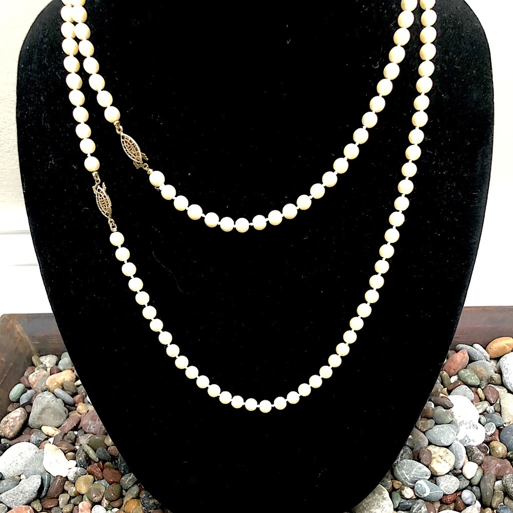 2 faux pearl necklaces with safety clasps.